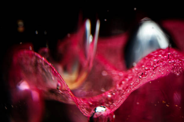 Abstract blurred photo of red blown glass. Red and black abstract background. Extreme macro.