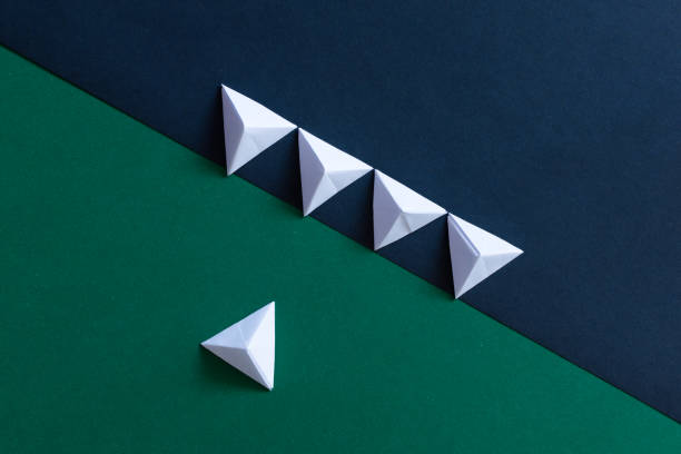 istock Green and black origami background. Confrontation, majority and minority concept 1360205218