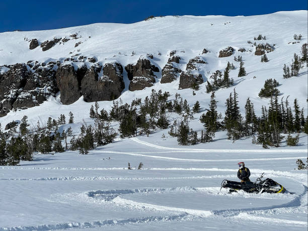 istock Snowmobiling and Skiing in the mountains above Lake Tahoe 1360206880