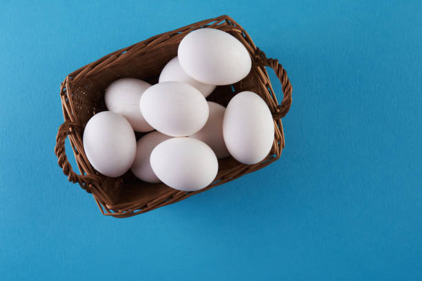 istock top view of basket of egg on blue background 1360207051