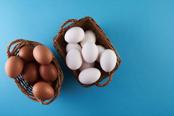istock top view of basket of egg on blue background 1360207057