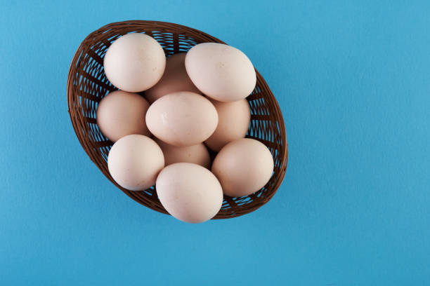 istock top view of basket of egg on blue background 1360207080