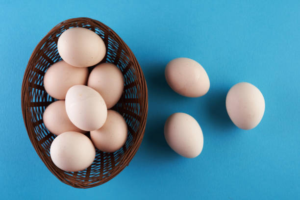 istock top view of basket of egg on blue background 1360207094