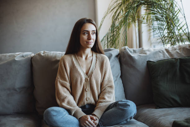 istock A young girl sitting at home on the couch 1360207461