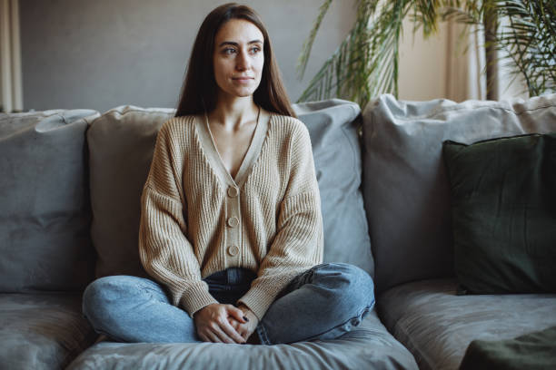 istock A young girl sitting at home on the couch 1360208073