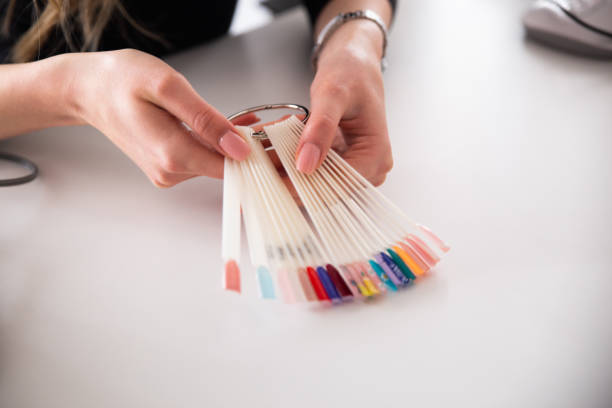 Manucured Women Hand with Multi Colored Nail Polish