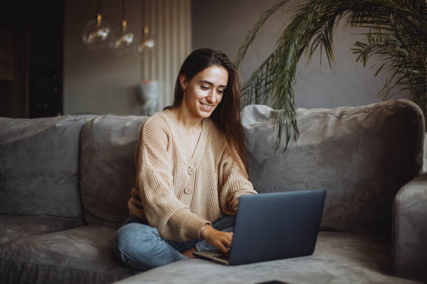 istock Smiling young girl using laptop 1360208249