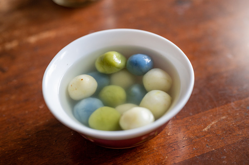 Image of Tangyuan (glutinous rice dumpling balls) for Winter Solstice festival food on wooden table background.