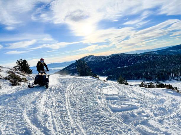 istock Snowmobiling and Skiing in the mountains above Lake Tahoe 1360209282