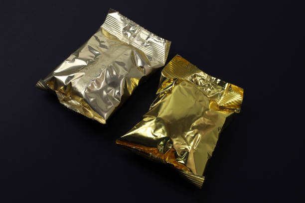 istock Foil bags for sweets on a black background. 1360209506
