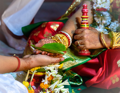 Kolkata, India, November 29,2021: Hands of Bride and Groom with Betel or Paan Leaf at the Time of Indian Hindu Bengali Wedding. Selective Focus is used.