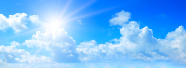 istock Blue sky, sun and clouds. Wide photo. 1360211867