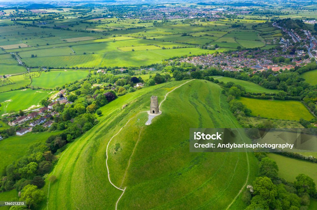 Glastonbury tor filmed from drone on sunny day, iconic monument in the middle of the countryside Glastonbury tor filmed from drone on sunny day, footage was taken from dji mavic pro 2 drone, iconic monument in the middle of the countryside Glastonbury - England Stock Photo