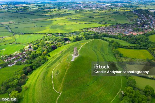 Glastonbury Tor Filmed From Drone On Sunny Day Iconic Monument In The Middle Of The Countryside Stock Photo - Download Image Now