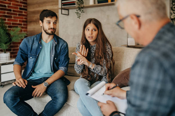istock Young couple in counseling session with a therapist 1360213528