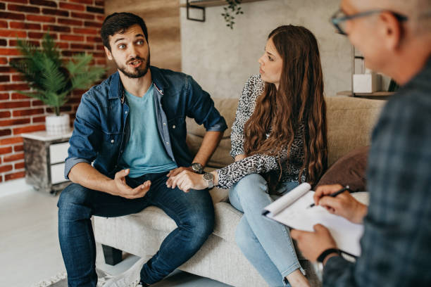 istock Young couple in counseling session with a therapist 1360213551