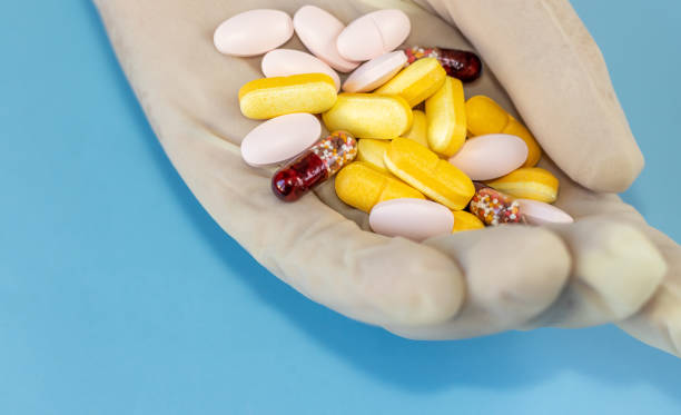 istock colorful pills in a woman's hand 1360213767