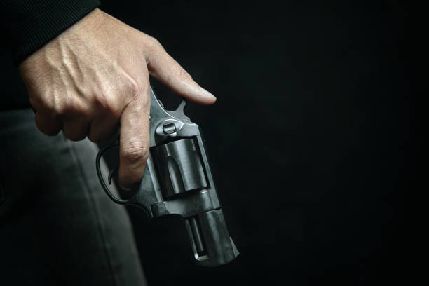istock Black revolver with drum in man's hand. 1360215681
