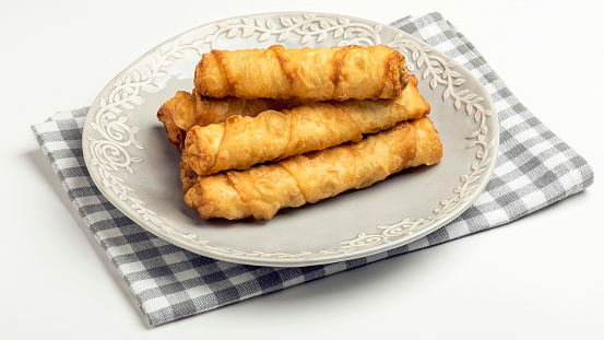 Fried spring rolls made by phyllo dough on white background.