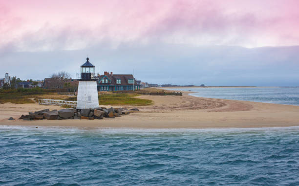 istock Seascape with Brant Point Lighthouse and dramatic pink clouds cape at twilight in Nantucket Massachusetts 1360216010