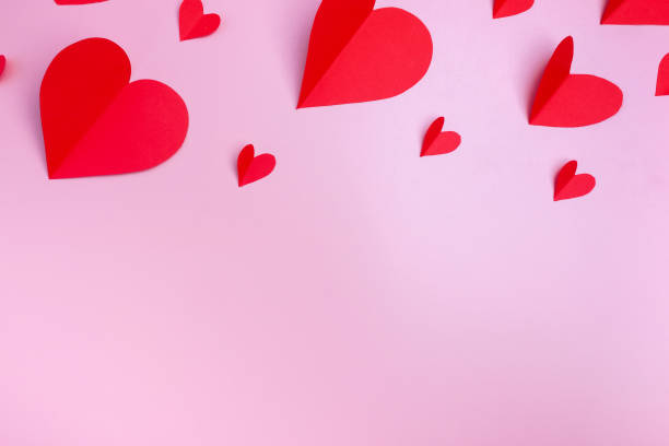 istock Red hearts on a pink background. Flat layout, top view. Copy space. Valentine's Day concept 1360216203
