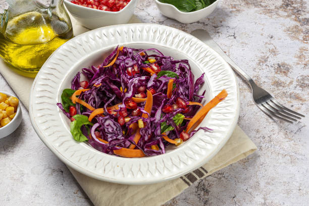 istock Homemade Purple Cabbage Salad with Corn, Carrots, Pomegranate and Spinach 1360216204