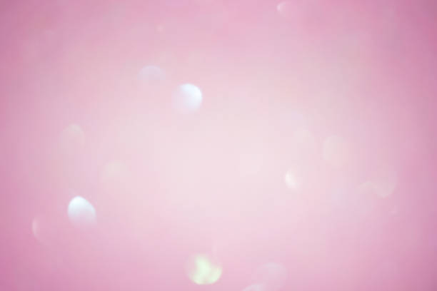 istock Abstract background blurred focus pink glitter. Pink sparkles defocus light. 1360219579