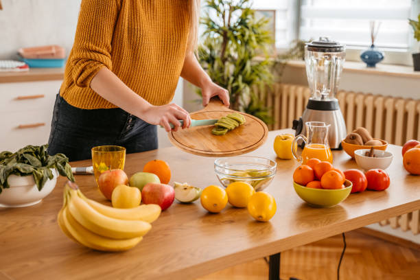 istock Cutting Kiwi For A Healthy Smoothie 1360220801