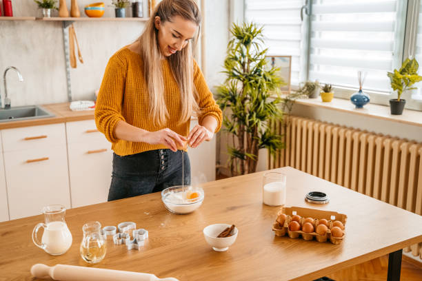 istock Young Woman Baking Cookies 1360221347