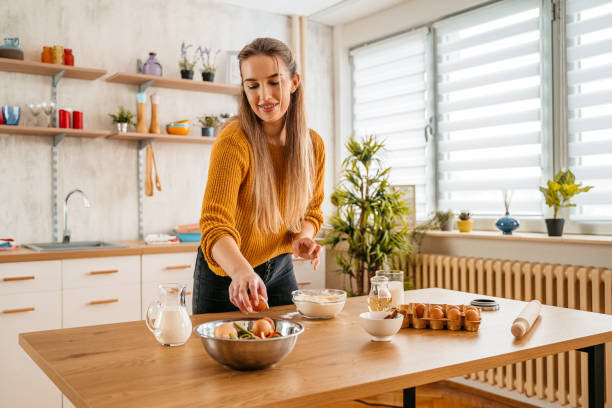 istock Young Woman Collecting Food Leftovers For Compost 1360221873