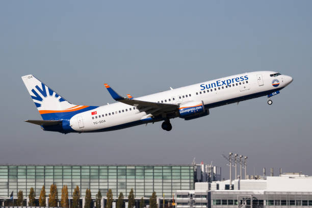 Sunexpress passenger plane at airport. Schedule flight travel. Aviation and aircraft. Air transport. Global international transportation. Fly and flying. Munich, Germany - October 17, 2017: Sunexpress passenger plane at airport. Schedule flight travel. Aviation and aircraft. Air transport. Global international transportation. Fly and flying. sunexpress stock pictures, royalty-free photos & images