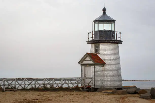 The landmark Brant Point Lighthouse, close-up image from the shore on an overcast day in Nantucket MA