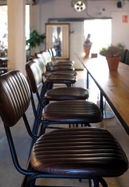 istock Row of leather seats next to a wooden table 1360222462