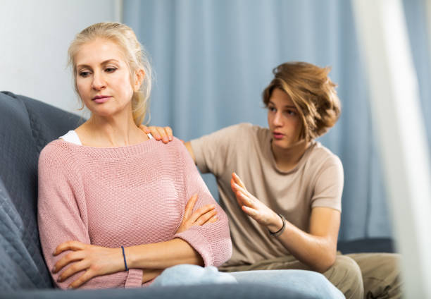 istock Mother and son sitting after quarrel at home 1360223442