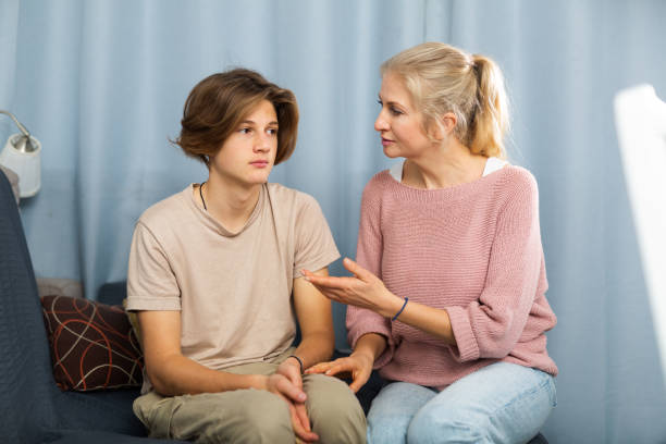 istock Mother and son sitting after quarrel at home 1360223446