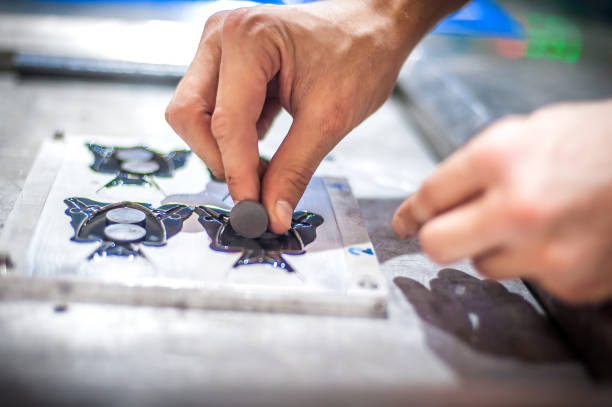 istock Technician making fridge magnet with soft PVC rubber in mold 1360225216