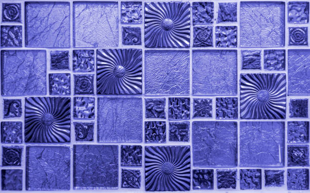 Shiny mosaic background of seamless full-frame tiles in PANTONE 17-3938 Very Peri colour stock photo