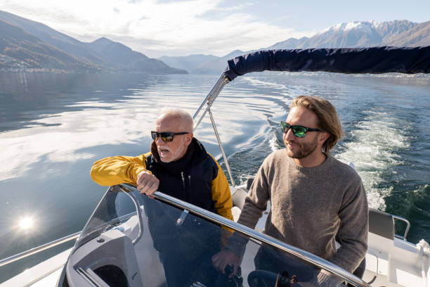 istock Weekend activity, Father and son boating on the lake 1360227047