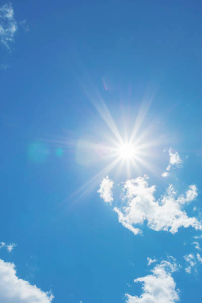 istock Bright sun with beautiful beams in the sky with light clouds 1360227189