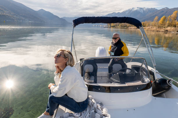 istock People enjoying a boat trip on calm lake waters 1360227394