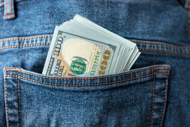 istock Dollar bills in jeans pocket 1360227561