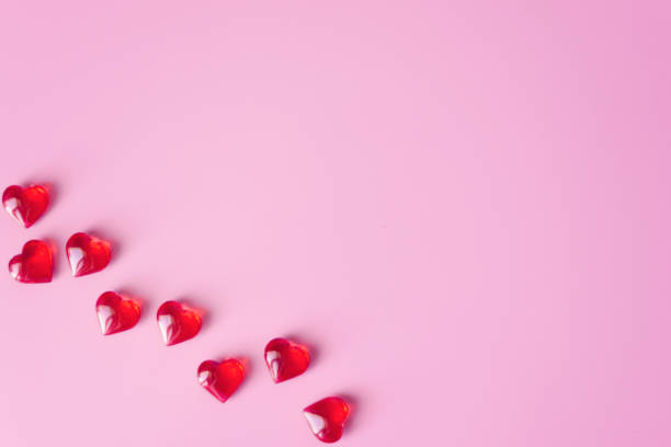 istock Glass hearts on pink background 1360227647