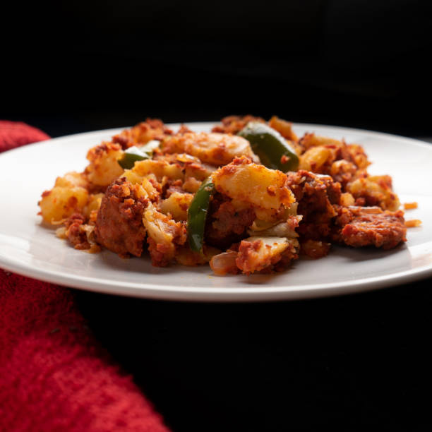 istock Potatoes with chorizo on a dark background.  Mexican food 1360227836