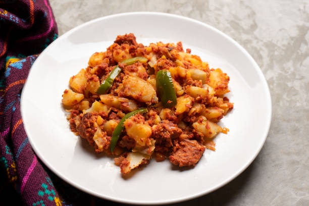 istock Potatoes with chorizo on a gray background.  Mexican food 1360227877