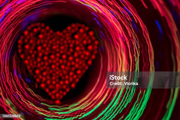 Glittering Red Heart Inside The Glowing Multi Colored Circles Stock Photo - Download Image Now