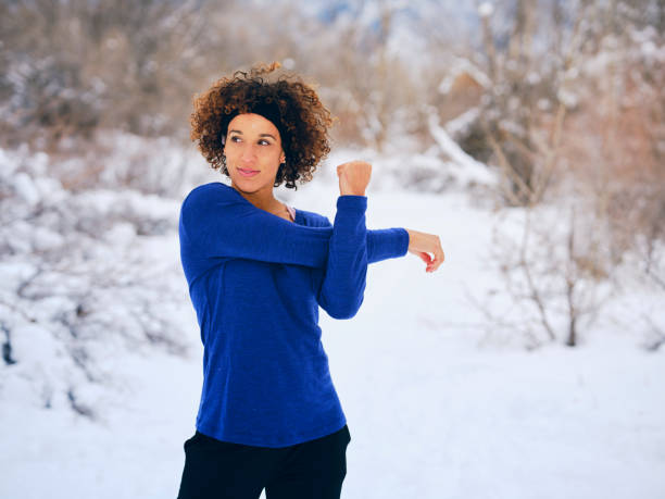istock A Woman Stretching Before a Winter Run 1360228816