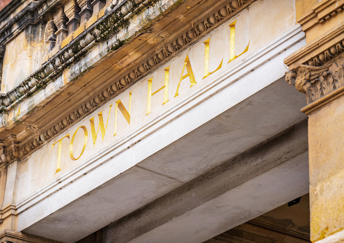 An old-fashioned Town Hall entrance sign.