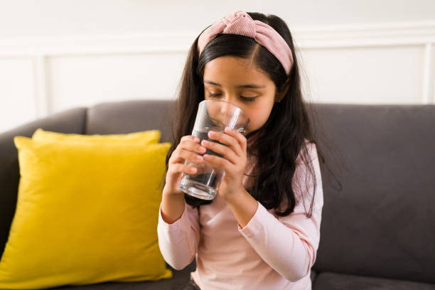 istock Healthy little girl drinking water 1360229148