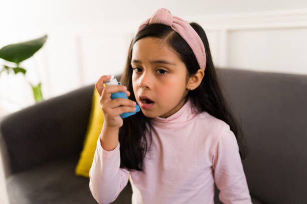istock Latin child using an asthma inhaler 1360229185