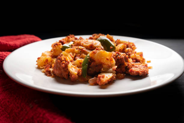 istock Potatoes with chorizo on a dark background.  Mexican food 1360230278